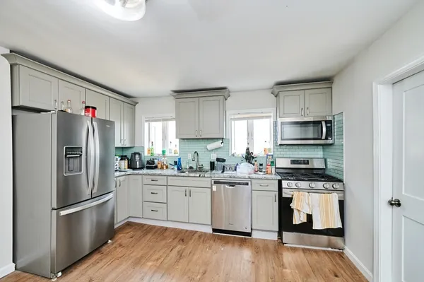 a kitchen with stainless steel appliances a refrigerator stove microwave and sink