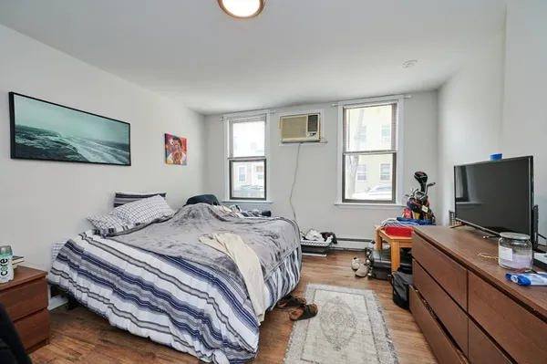 a bedroom with a bed and a flat screen tv