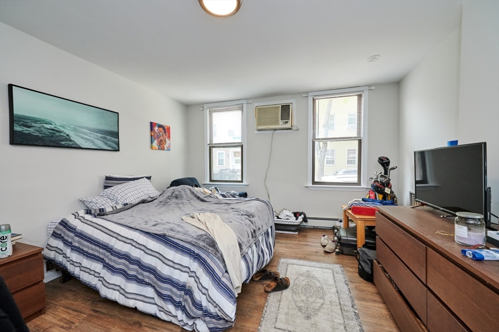 241-243 E Street Boston, MA 02127 - Photo 8 of 16 a bedroom with a bed and a flat screen tv