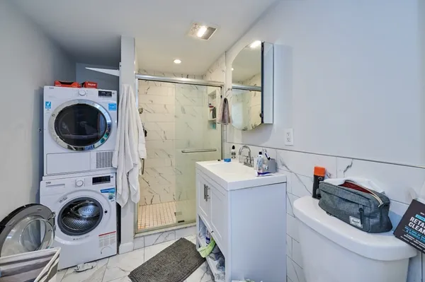 a bathroom with a sink a washer and dryer