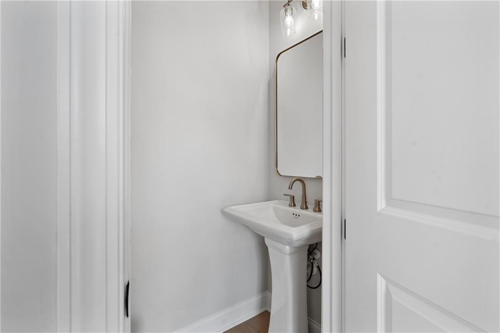 502 Whatton Road, Unit 1 Johns Creek, GA 30022 - Photo 11 of 34 a bathroom with a sink a mirror and shower