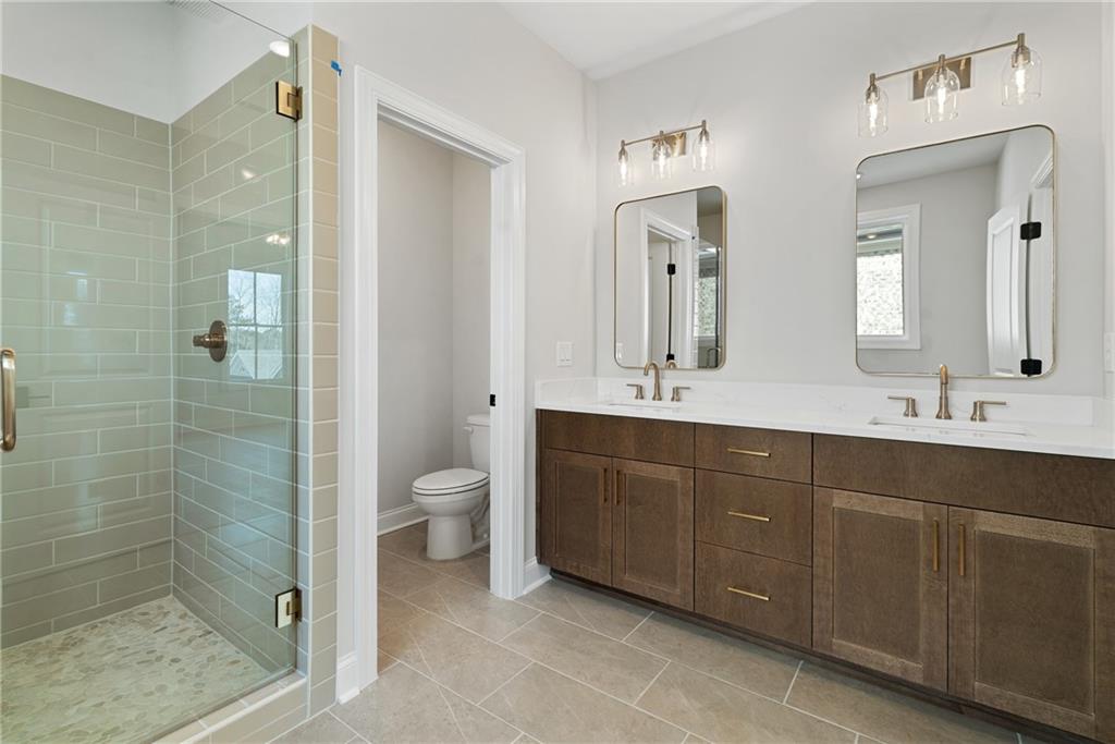 502 Whatton Road, Unit 1 Johns Creek, GA 30022 - Photo 19 of 34 a bathroom with a double vanity sink mirror and toilet