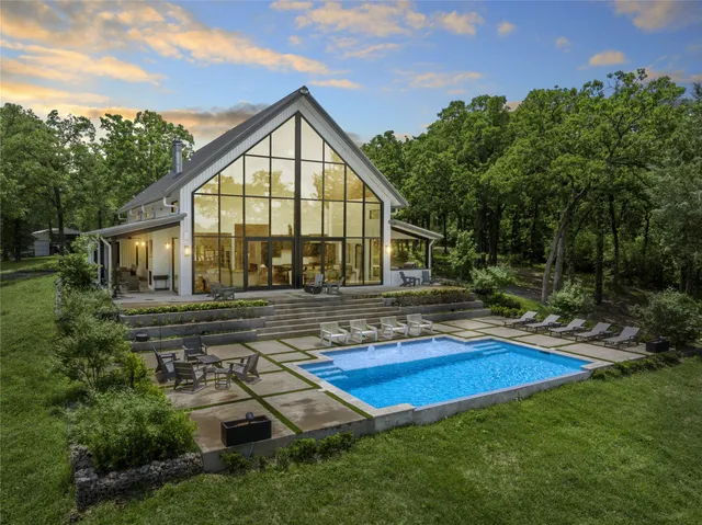 a view of an house with backyard and sitting area