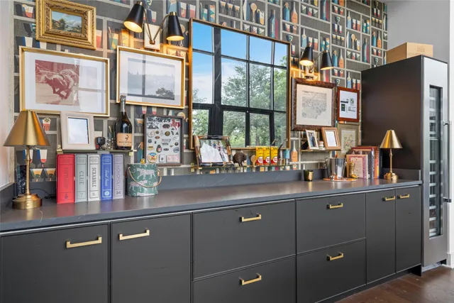 a kitchen with lots of clutter and cabinets