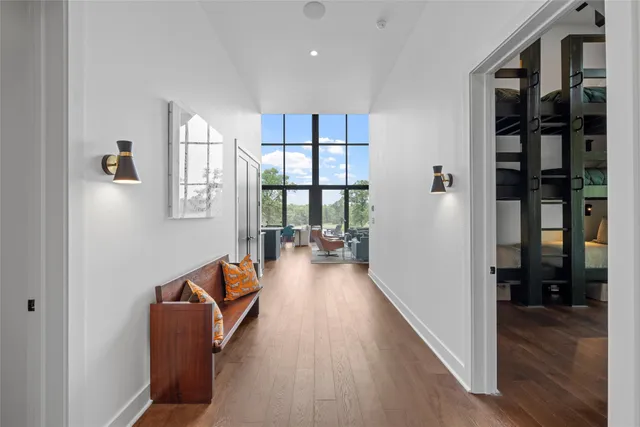 a hallway with wooden floor and furniture