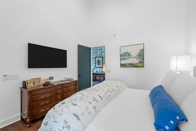 a bedroom with a bed and a flat screen tv