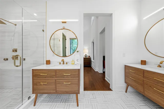 a bathroom with a sink a mirror and a shower