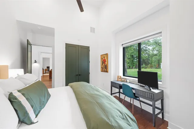 a bedroom with a bed and large window