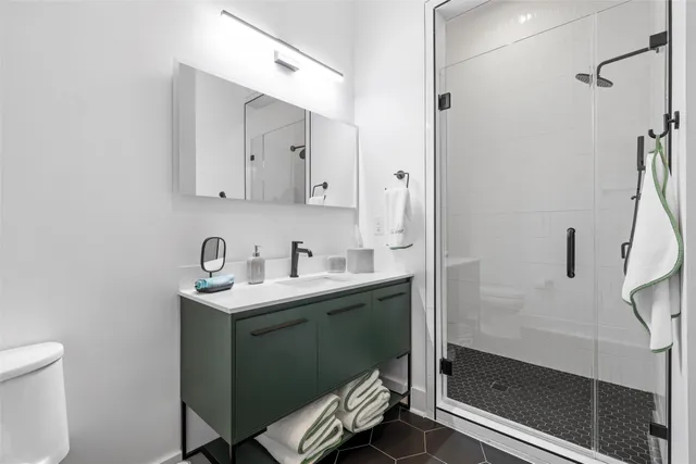a bathroom with a sink toilet and shower