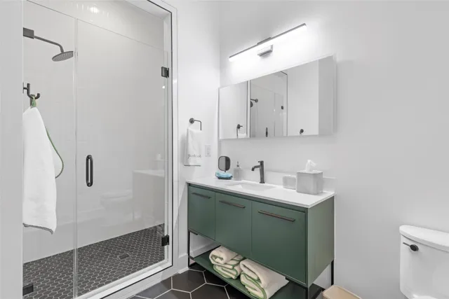 a bathroom with a sink toilet and shower