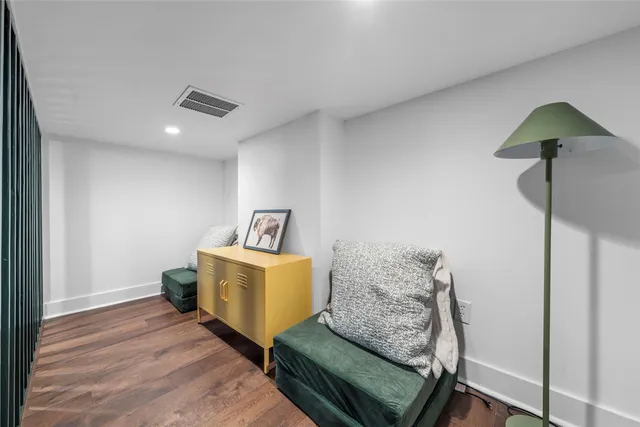 a living room with furniture and a wall painting