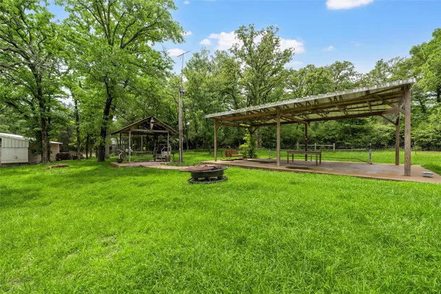 a view of a car park with large trees