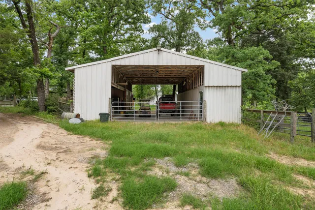 a view of swimming pool with seating area and trees in the background