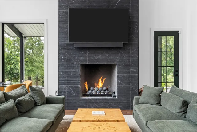 a living room with furniture and a fireplace