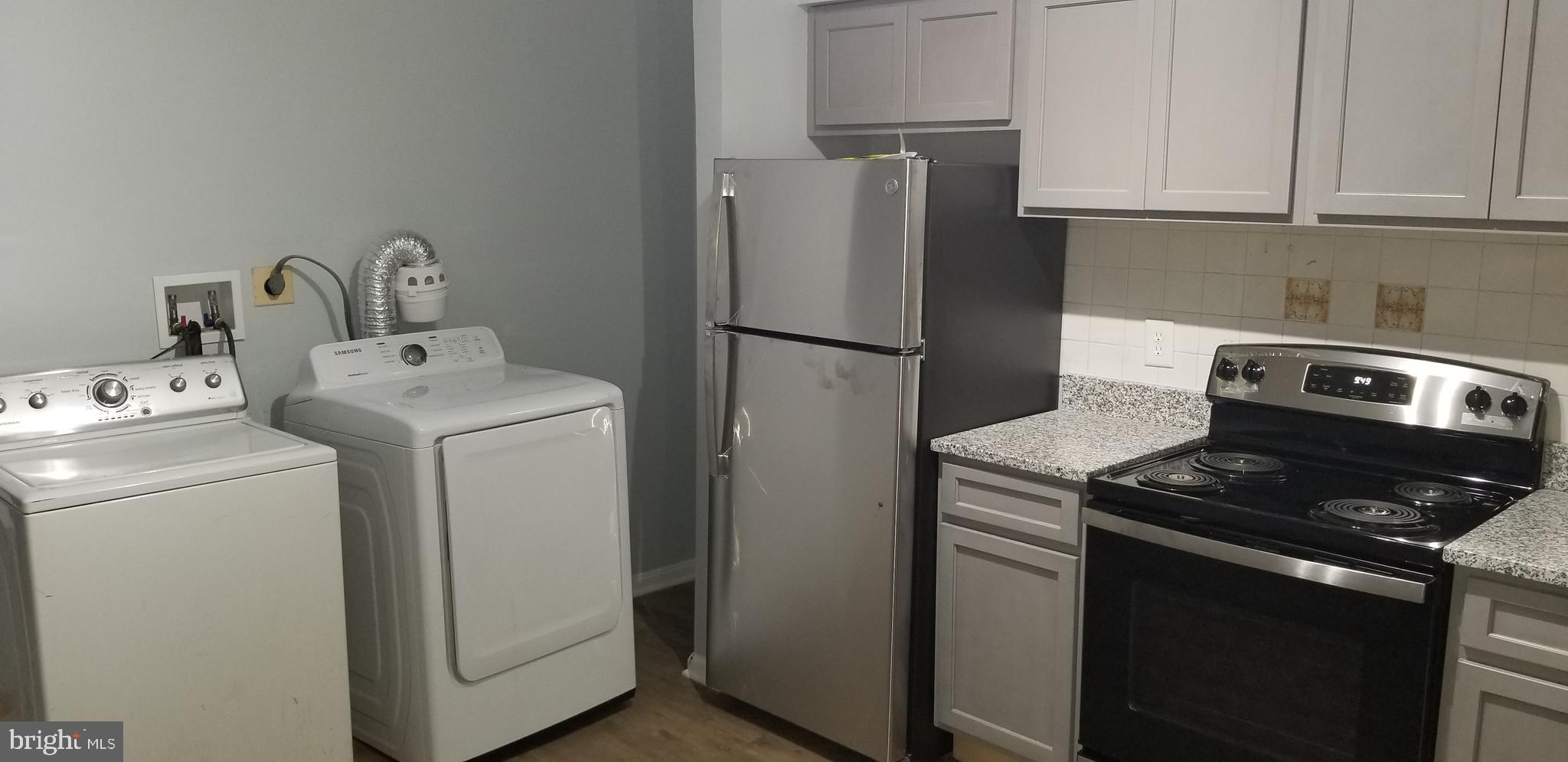 1624 West Lexington Street Baltimore, MD 21223 - Photo 19 of 63 a kitchen with a refrigerator sink and cabinets