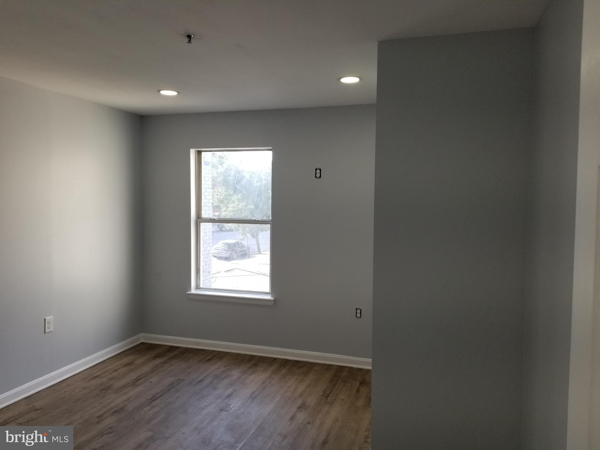 1624 West Lexington Street Baltimore, MD 21223 - Photo 29 of 63 an empty room with wooden floor and windows