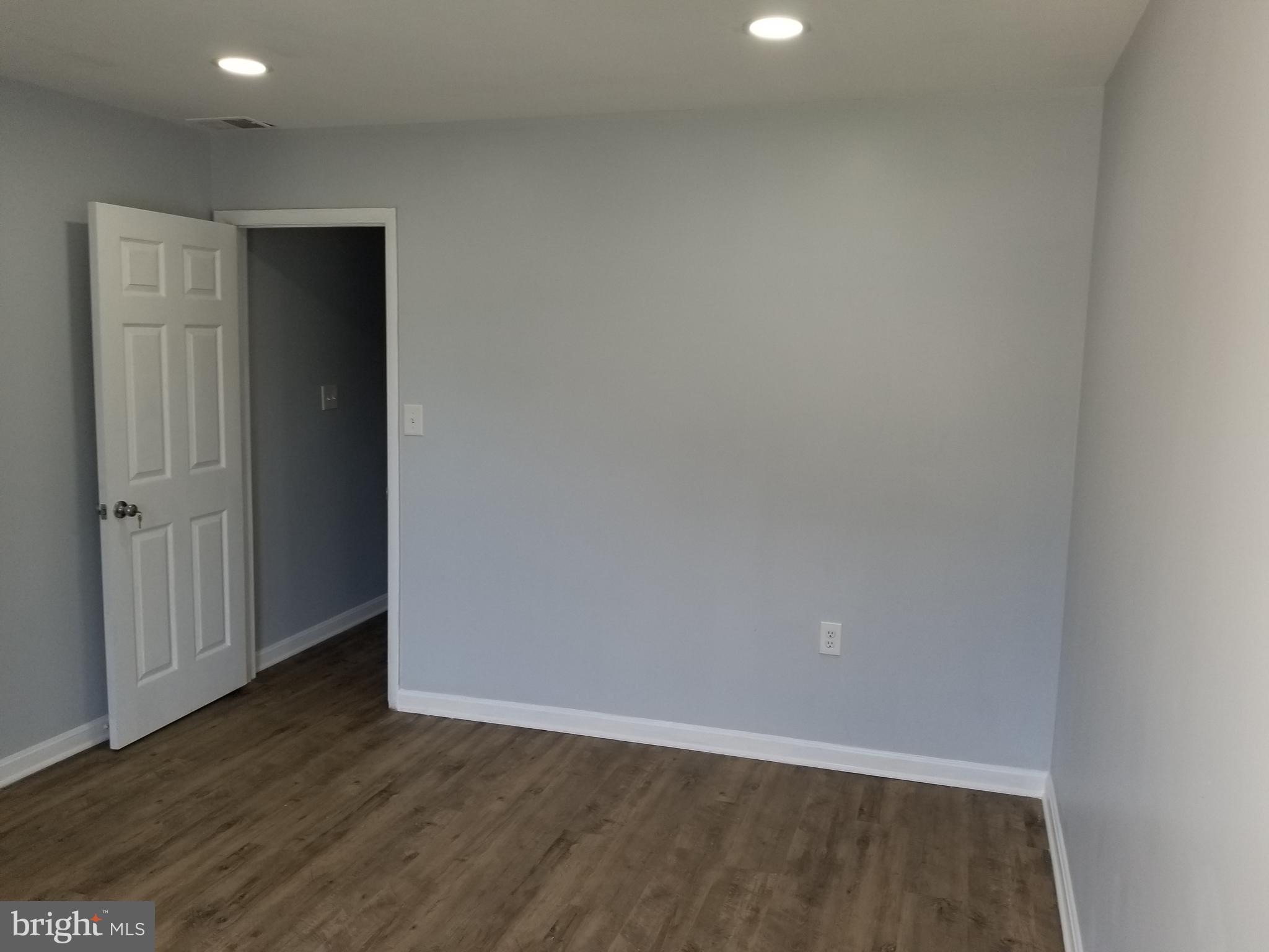 1624 West Lexington Street Baltimore, MD 21223 - Photo 31 of 63 a view of an empty room with wooden floor
