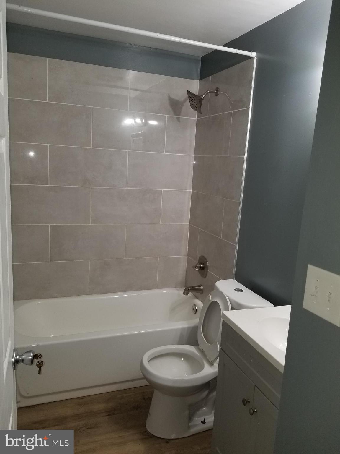 1624 West Lexington Street Baltimore, MD 21223 - Photo 32 of 63 a bathroom with a sink toilet and shower