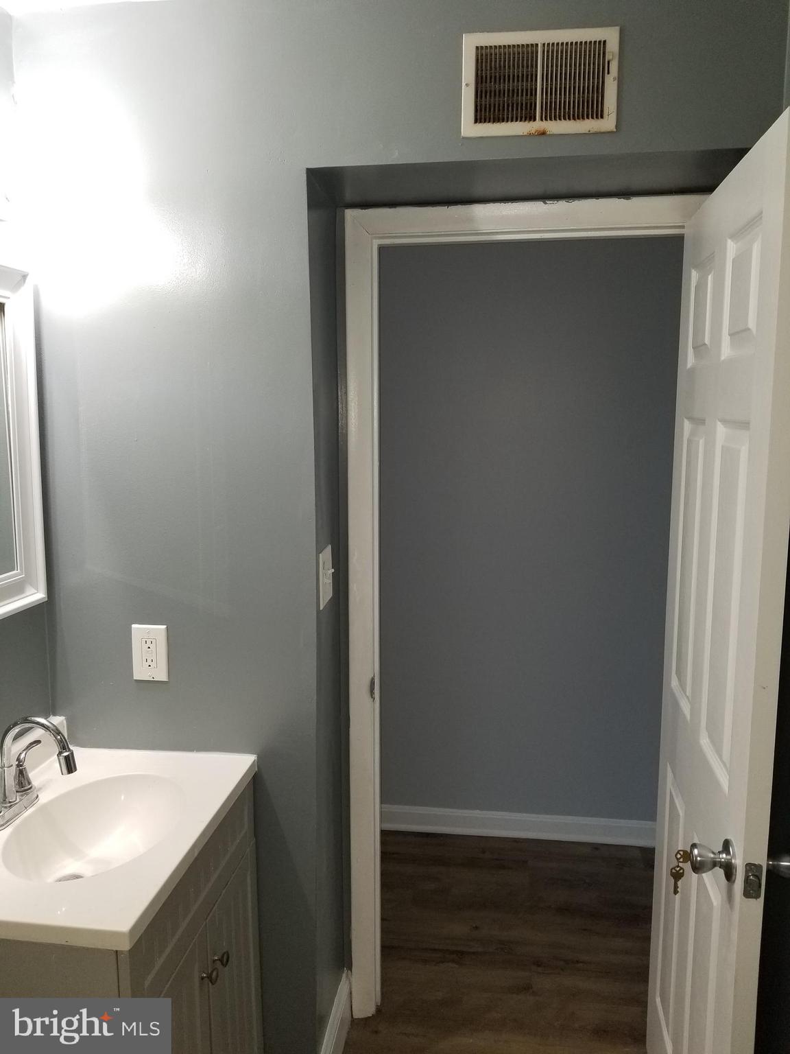 1624 West Lexington Street Baltimore, MD 21223 - Photo 34 of 63 a bathroom with a sink and a mirror