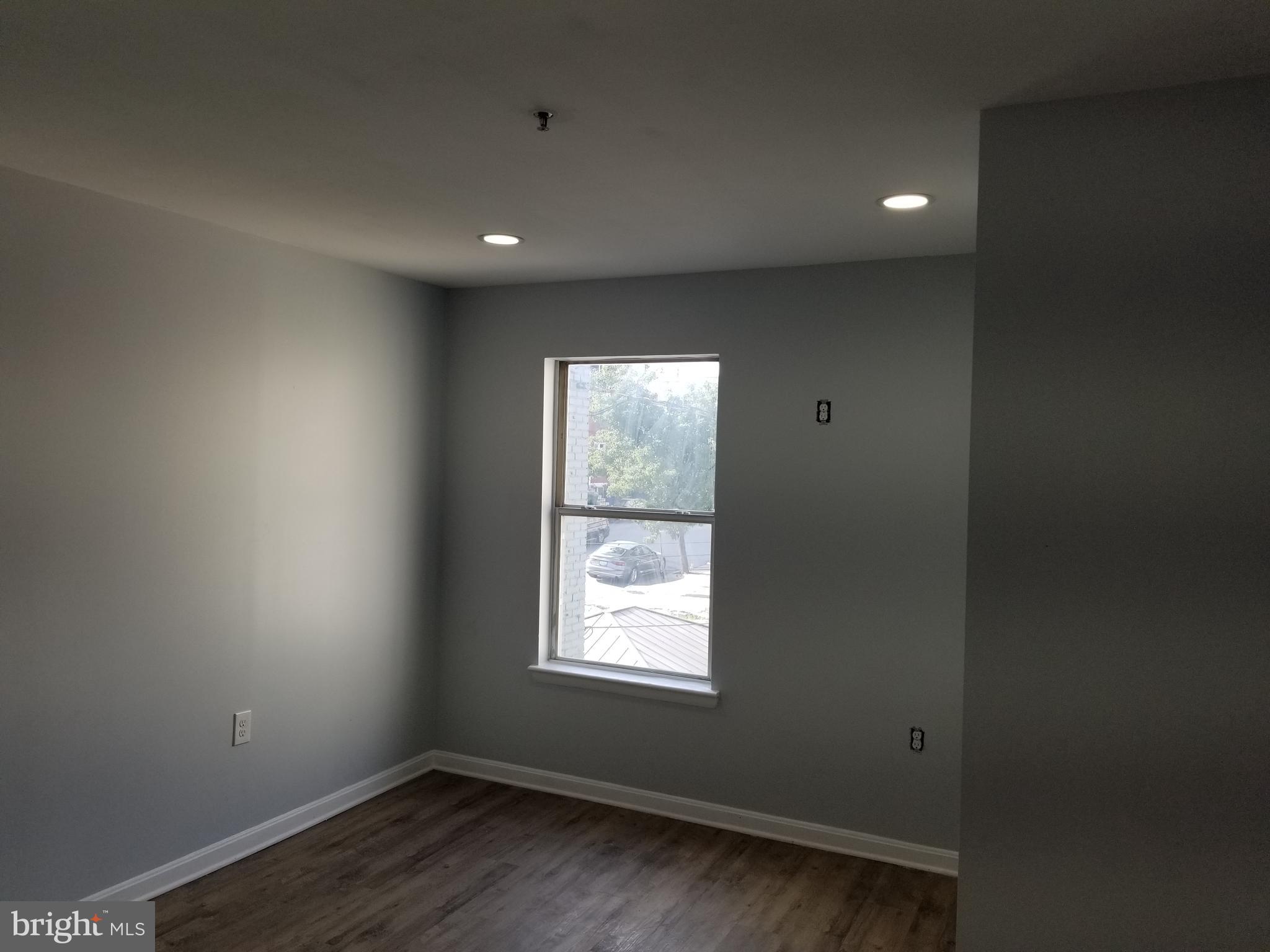 1624 West Lexington Street Baltimore, MD 21223 - Photo 40 of 63 an empty room with wooden floor and windows
