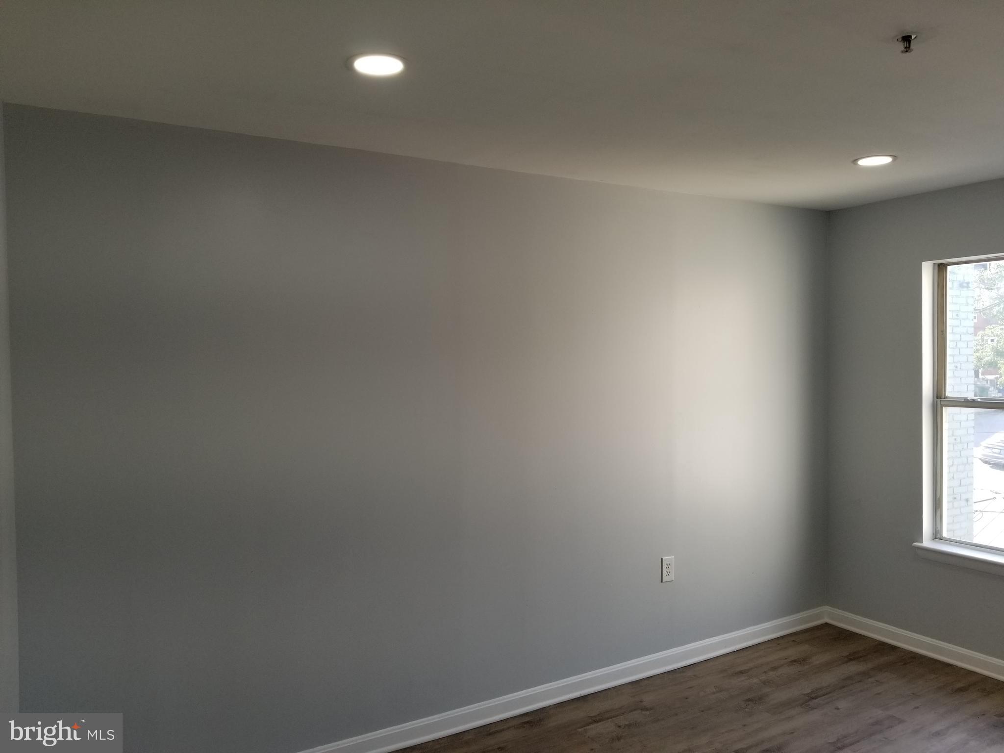 1624 West Lexington Street Baltimore, MD 21223 - Photo 41 of 63 an empty room with wooden floor and windows