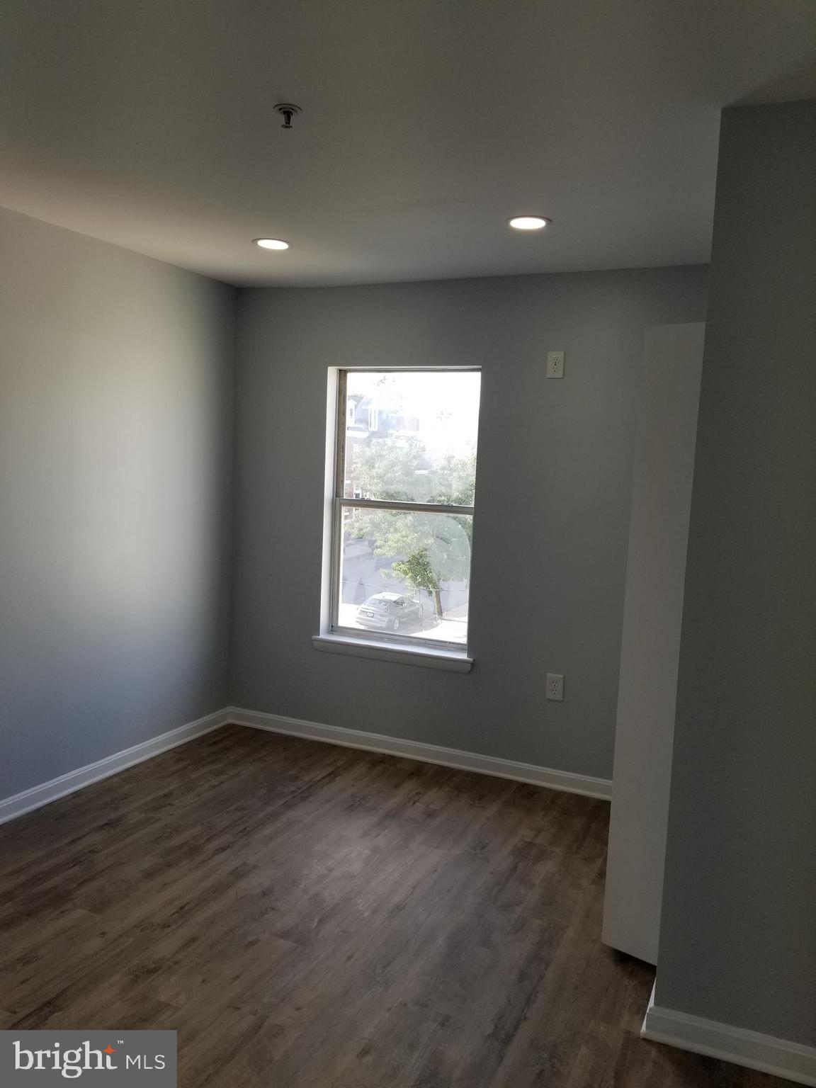 1624 West Lexington Street Baltimore, MD 21223 - Photo 47 of 63 an empty room with wooden floor and windows