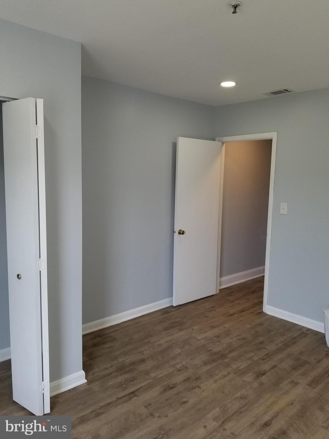 1624 West Lexington Street Baltimore, MD 21223 - Photo 48 of 63 a view of an empty room with wooden floor and closet