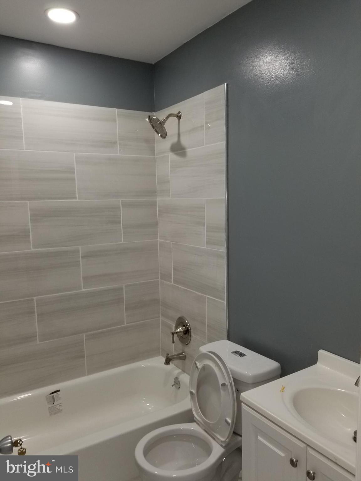 1624 West Lexington Street Baltimore, MD 21223 - Photo 51 of 63 a bathroom with a sink a toilet and shower