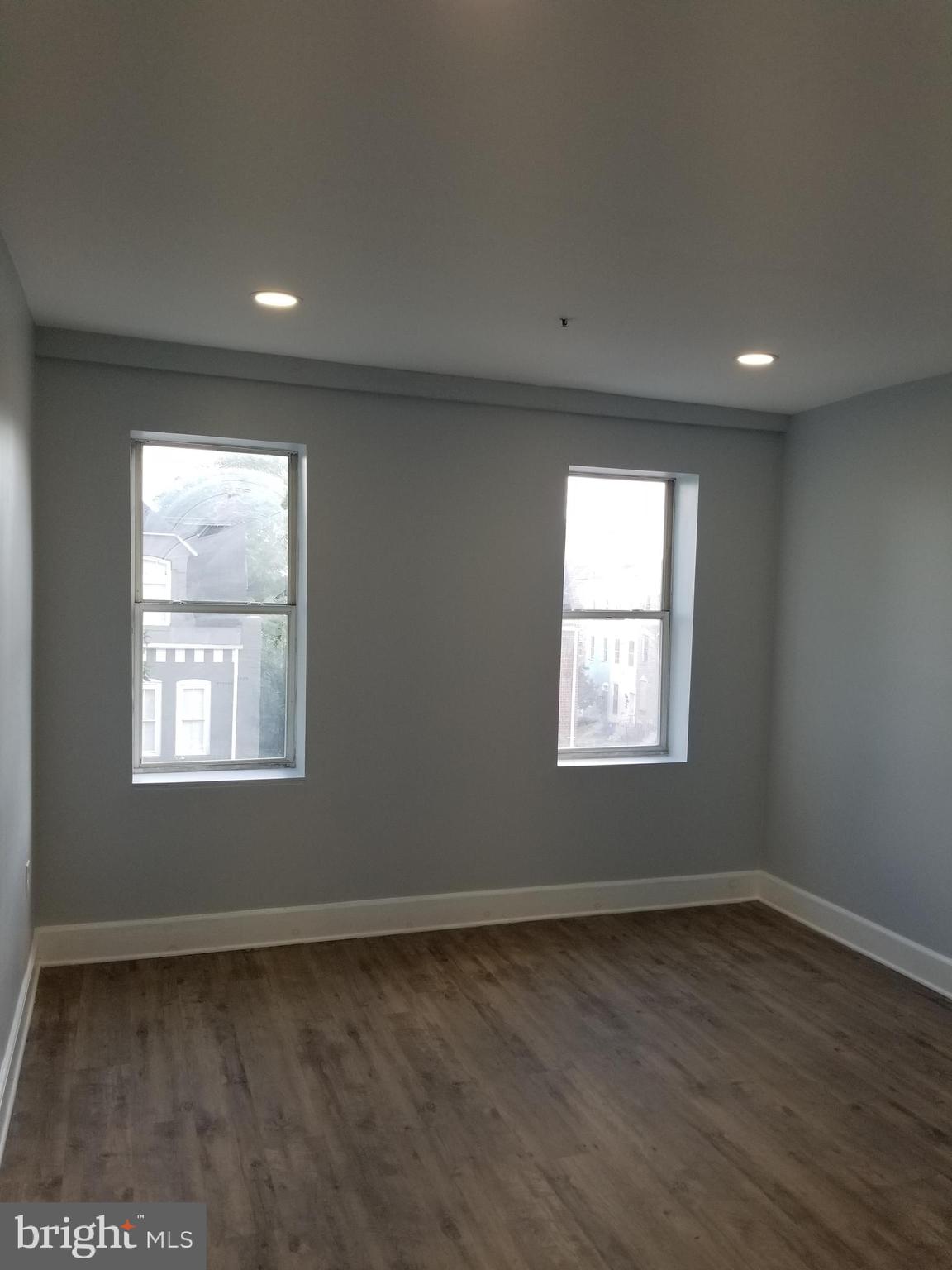 1624 West Lexington Street Baltimore, MD 21223 - Photo 53 of 63 an empty room with wooden floor and windows