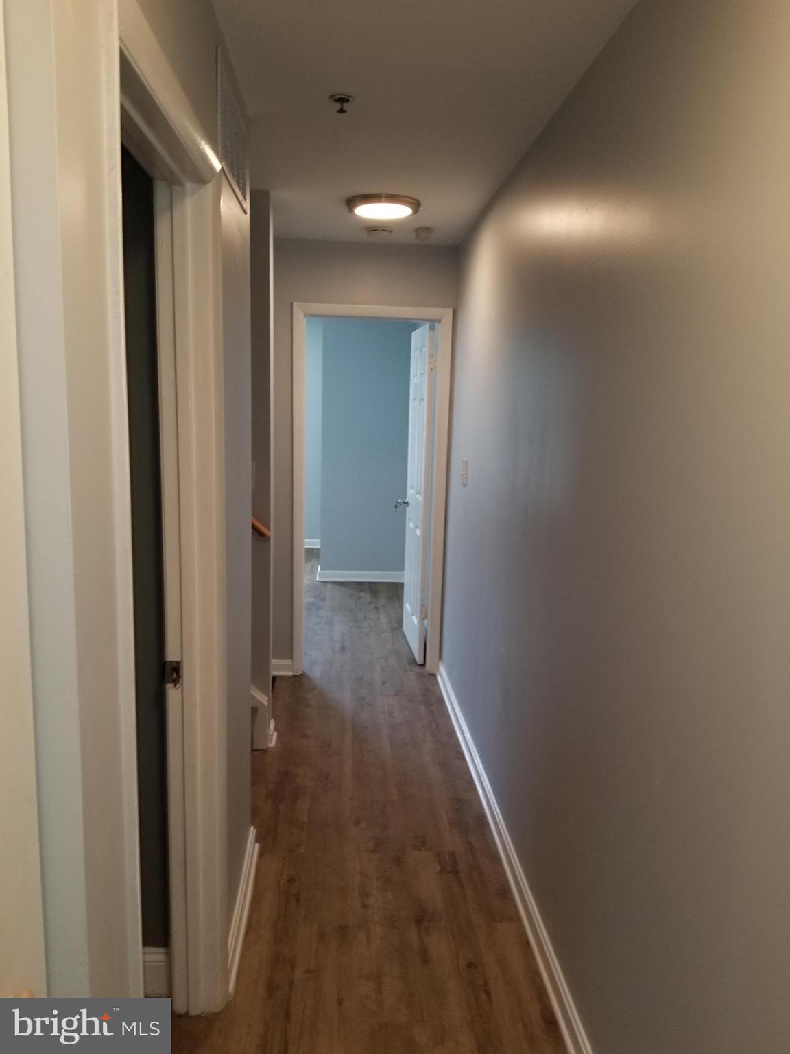 1624 West Lexington Street Baltimore, MD 21223 - Photo 6 of 63 a view of a hallway with wooden floor