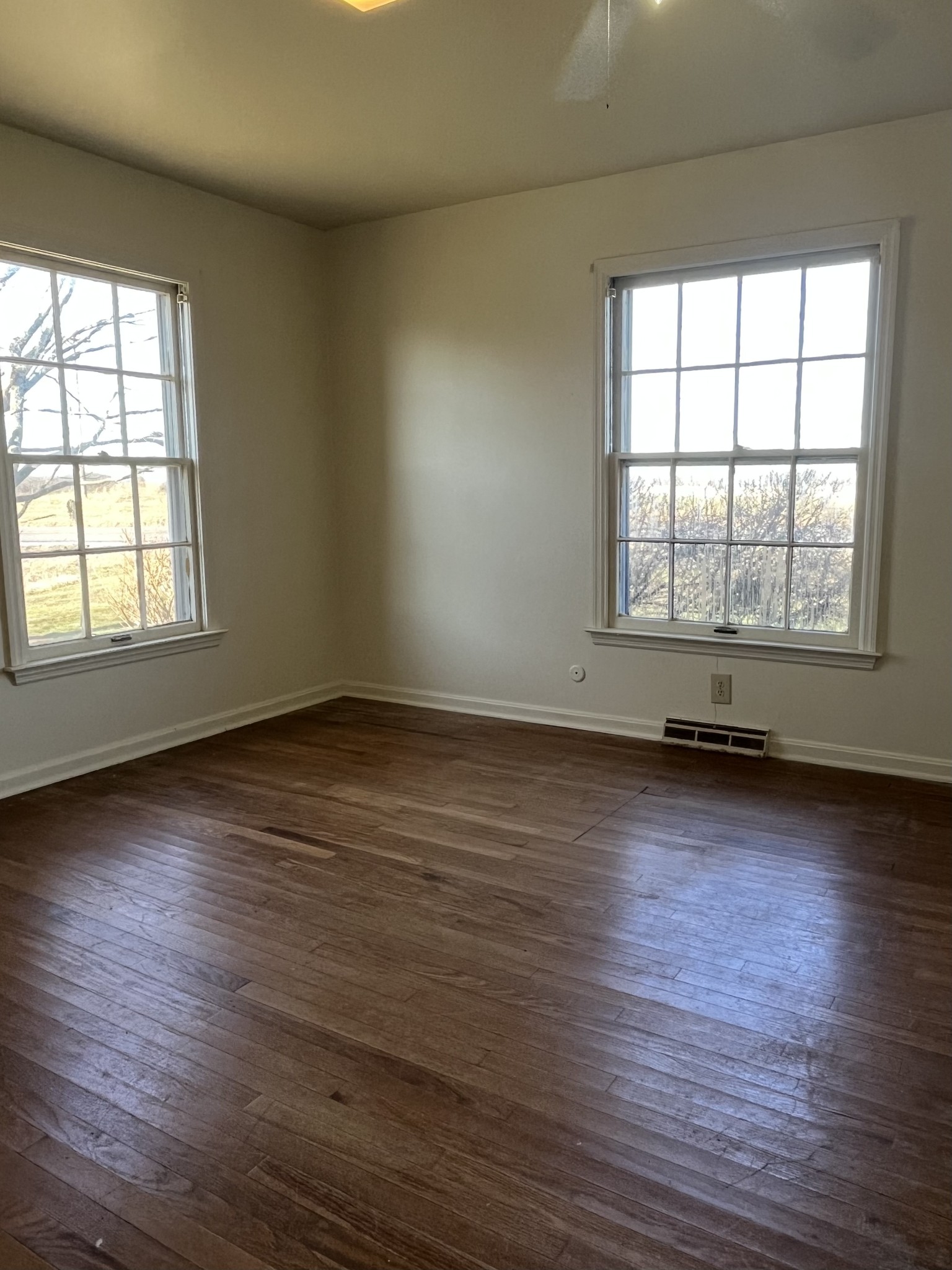 14403 Newstead Road Herndon, KY 42236 - Photo 17 of 25 an empty room with wooden floor and windows with curtains view