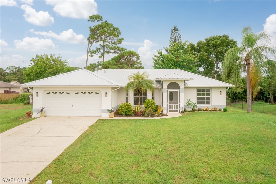 a front view of house with yard and outdoor seating