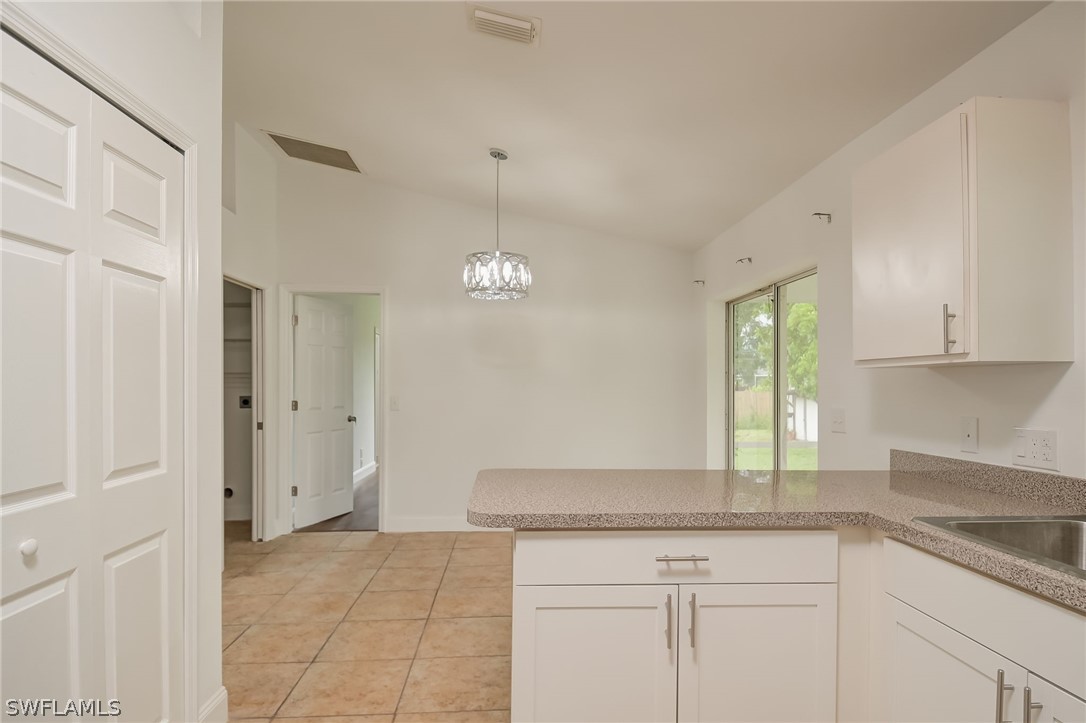 18298 Hepatica Road Fort Myers, FL 33967 - Photo 11 of 25 a kitchen with granite countertop a sink and a window