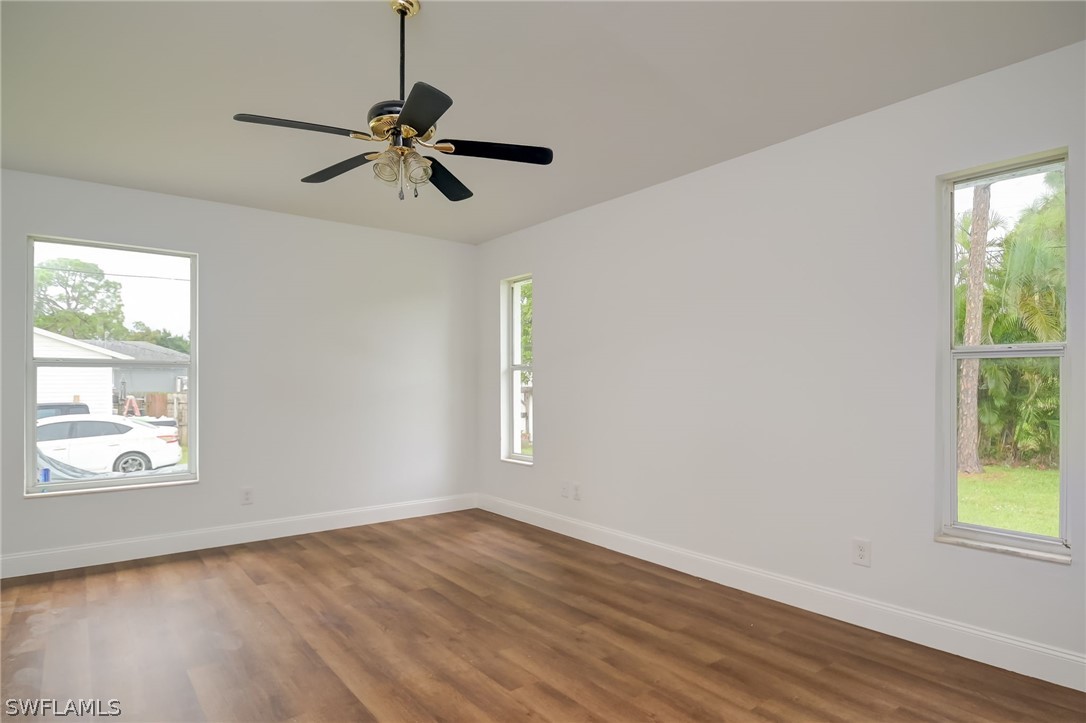 18298 Hepatica Road Fort Myers, FL 33967 - Photo 12 of 25 a view of an empty room with wooden floor and a window