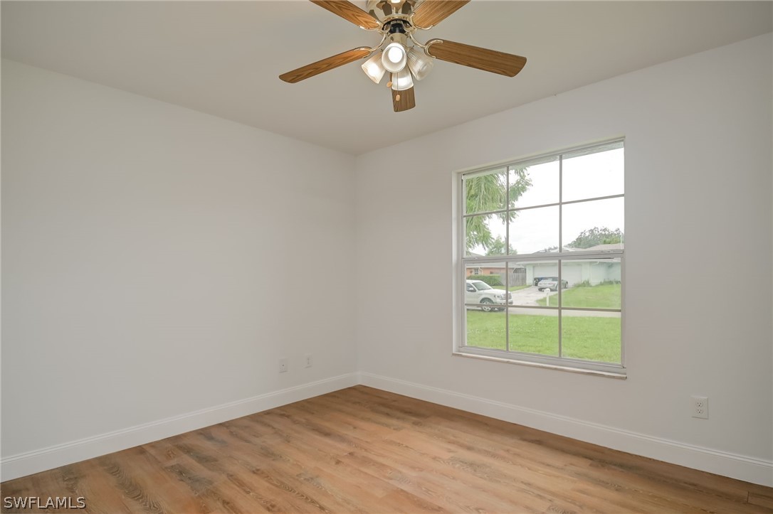 18298 Hepatica Road Fort Myers, FL 33967 - Photo 15 of 25 wooden floor in an empty room with a window