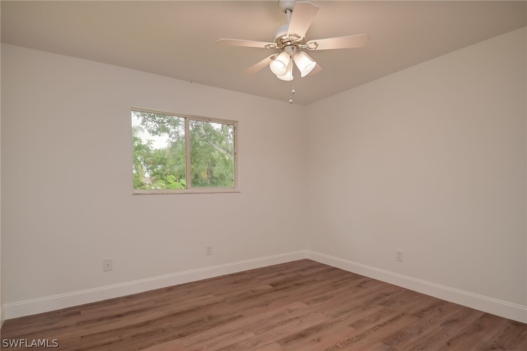 18298 Hepatica Road Fort Myers, FL 33967 - Photo 17 of 25 wooden floor in an empty room with a window
