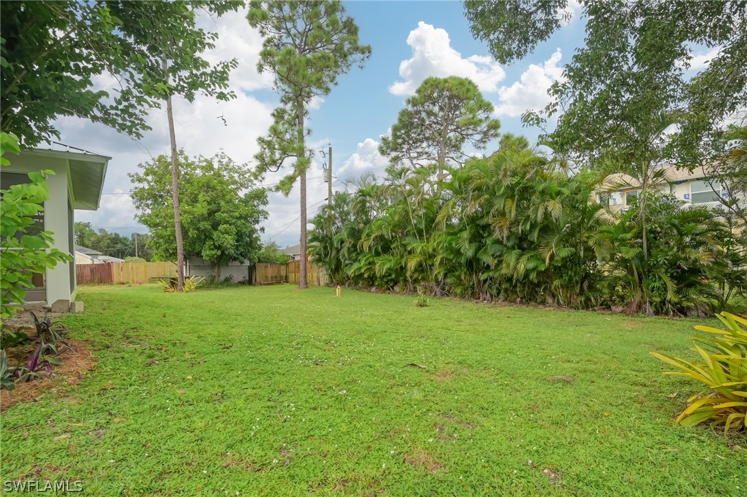 18298 Hepatica Road Fort Myers, FL 33967 - Photo 22 of 25 a view of a big yard with plants and a large tree