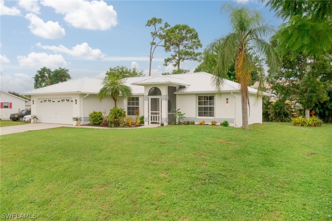 18298 Hepatica Road Fort Myers, FL 33967 - Photo 23 of 25 a front view of house with yard and green space