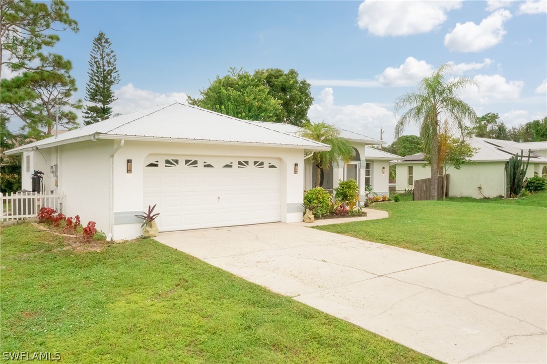 18298 Hepatica Road Fort Myers, FL 33967 - Photo 24 of 25 a front view of a house with a yard and trees