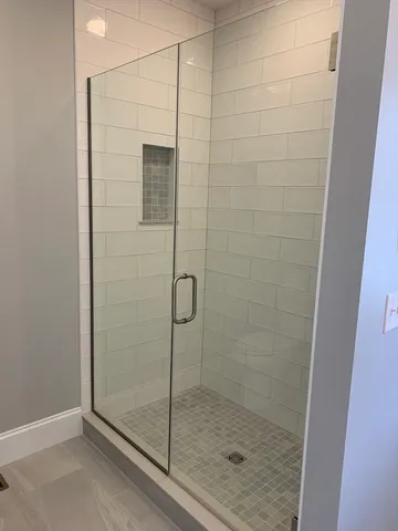 a bathroom with a glass shower door