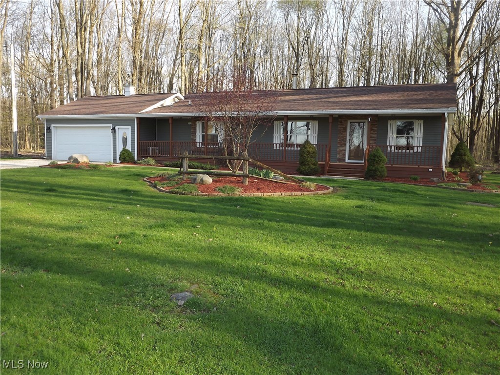 5880 Schramling Road Pierpont, OH 44082 - Photo 1 of 49 Ranch-style house featuring a porch, a front lawn, concrete driveway, and an attached garage