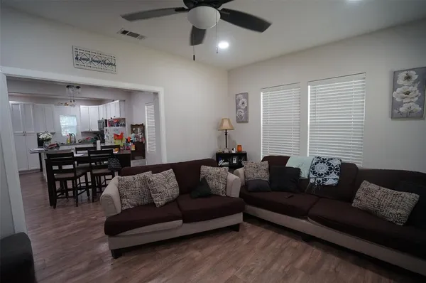 a living room with furniture and wooden floor