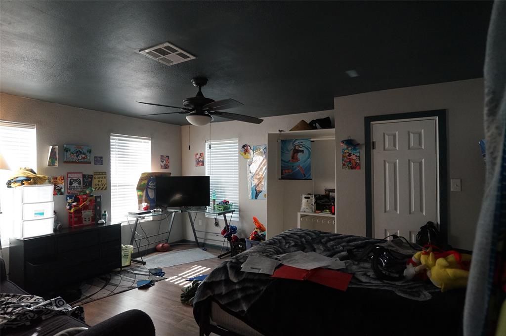 2115 Reuter Avenue Waco, TX 76708 - Photo 8 of 11 a bedroom with furniture and a flat screen tv