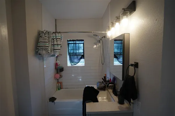 a bathroom with a bathtub and shower