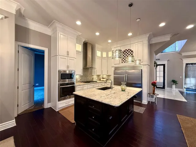 a large kitchen with a table and chairs