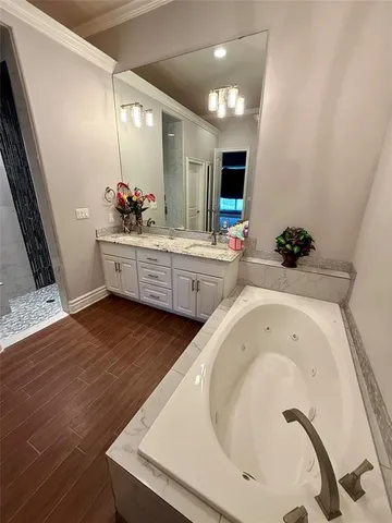 a large white kitchen with a sink a large mirror and vanity