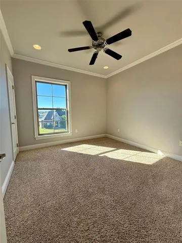 en empty room with windows and fan