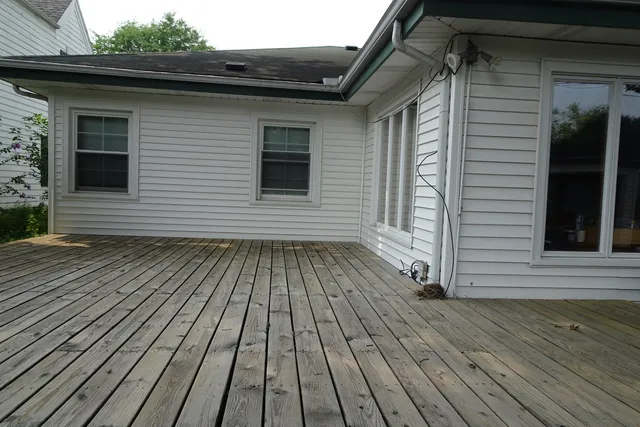 a view of a house with wooden deck