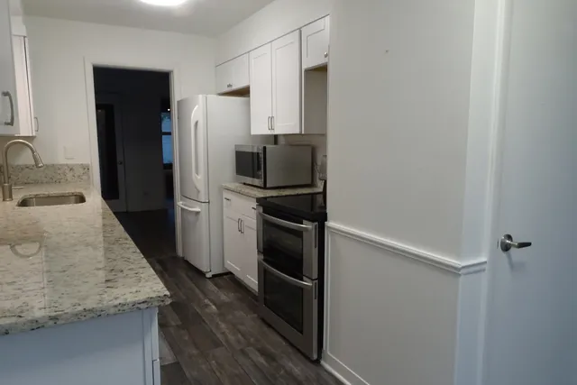 a kitchen with a refrigerator and a sink