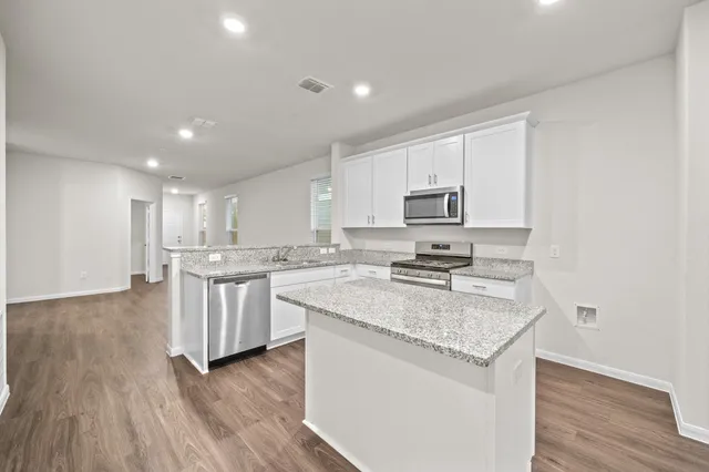 a kitchen with a sink microwave and cabinets
